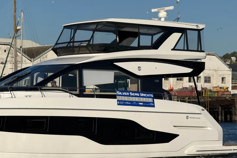 Slide: The Image of 2027 Cruisers Yachts 50 Fly at dock, featuring sleek design and modern architecture. - 3
