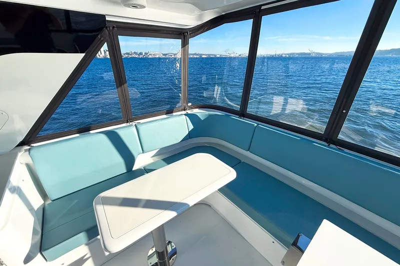 Slide: The Image of Luxurious interior of 2027 Cruisers Yachts 50 Fly with ocean view and seating area. - 47