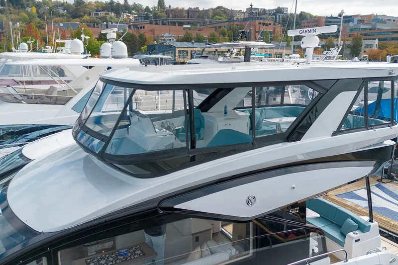 Slide: The Image of 2027 Cruisers Yachts 50 Fly luxury yacht docked at marina, showcasing sleek design. - 4