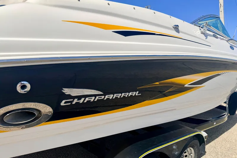 Slide: The Image of 2000 Chaparral 235 SSi boat with sleek design and vibrant yellow accents. - 10