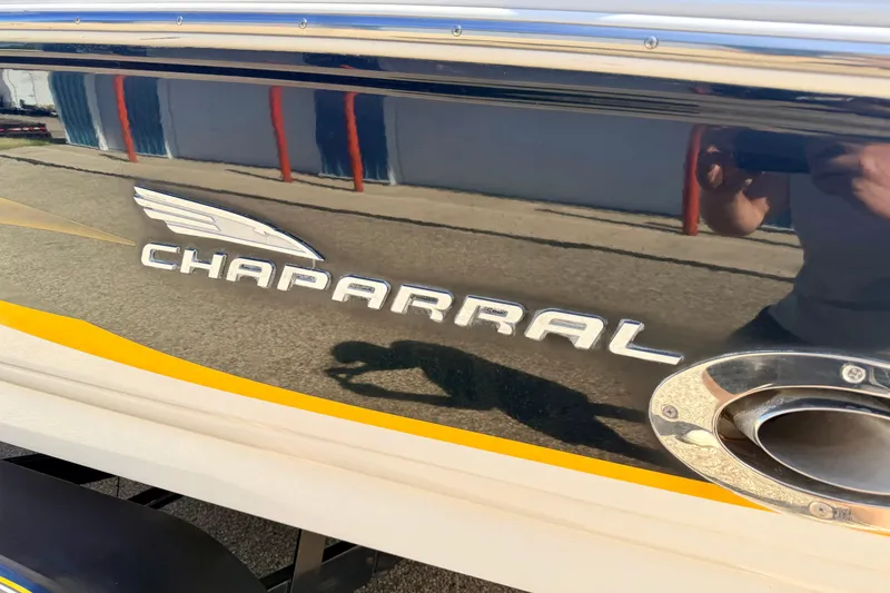 Slide: The Image of Chaparral 235 SSi 2000 boat logo on sleek black hull with yellow accent. - 12