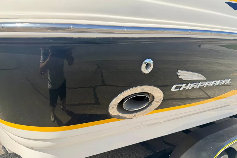 Slide: The Image of 2000 Chaparral 235 SSi boat side view with logo and exhaust detail. - 14