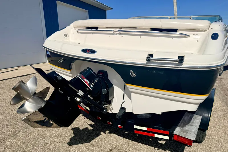 Slide: The Image of Rear view of a 2000 Chaparral 235 SSi boat with a Mercury engine. - 16
