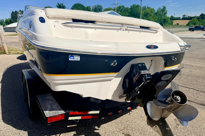 Slide: The Image of 2000 Chaparral 235 SSi boat on trailer, rear view with propeller visible. - 19