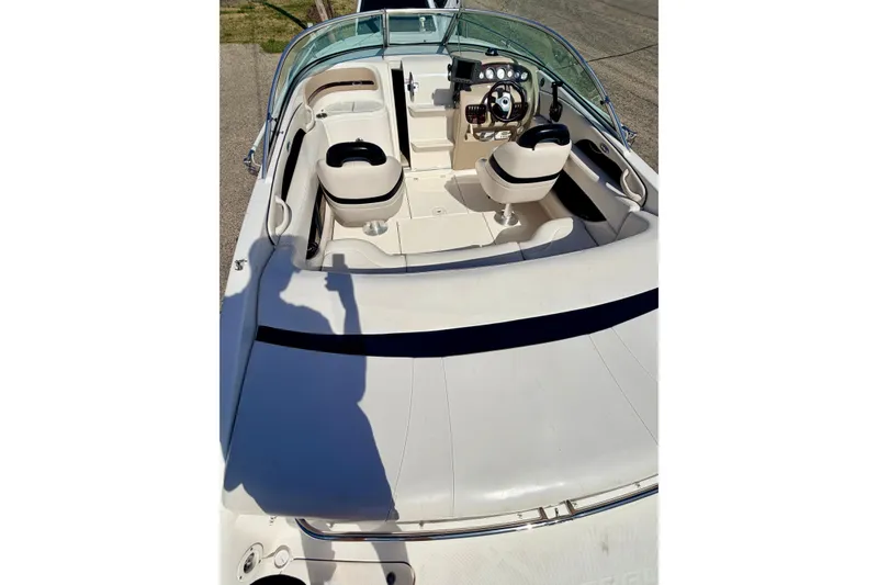 Slide: The Image of 2000 Chaparral 235 SSi boat interior with steering wheel and seating. - 22