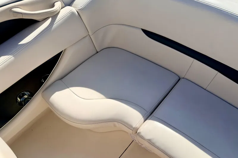Slide: The Image of Interior seating of 2000 Chaparral 235 SSi boat, featuring light beige upholstery. - 24