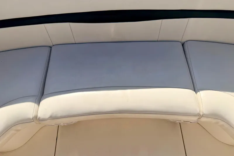 Slide: The Image of 2000 Chaparral 235 SSi boat interior with white cushioned seating. - 26