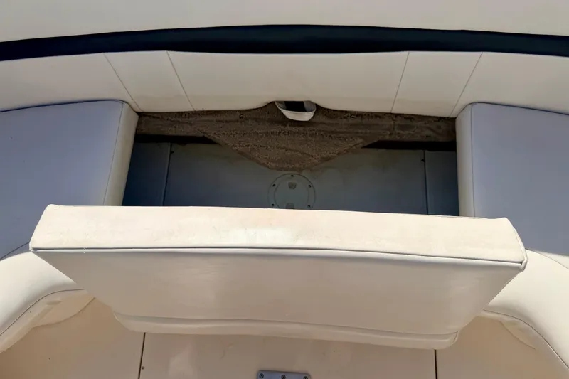 Slide: The Image of Interior seating of a 2000 Chaparral 235 SSi boat, featuring white upholstery. - 27