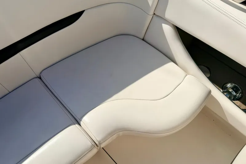 Slide: The Image of White leather seating on a 2000 Chaparral 235 SSi boat interior. - 29