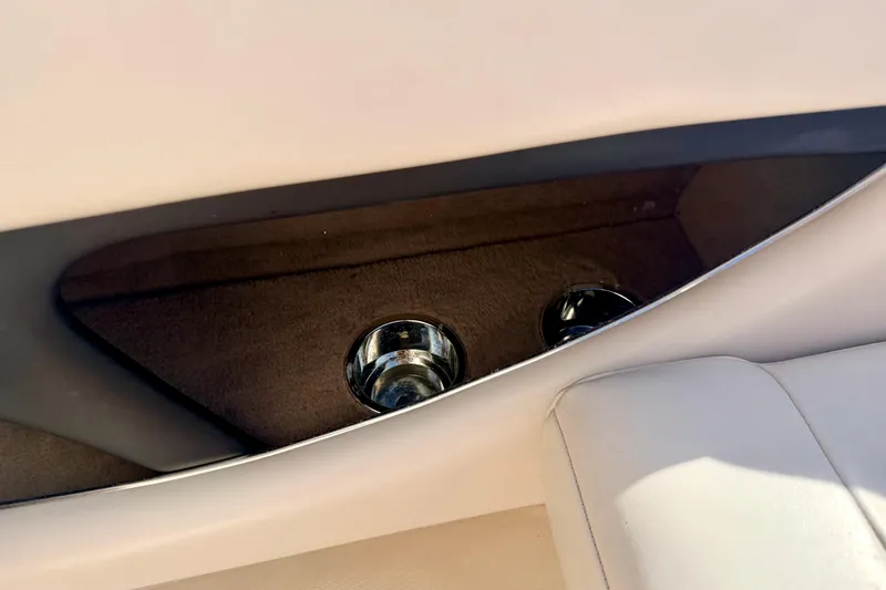 Slide: The Image of Interior of 2000 Chaparral 235 SSi boat showing cup holders and beige seating. - 31