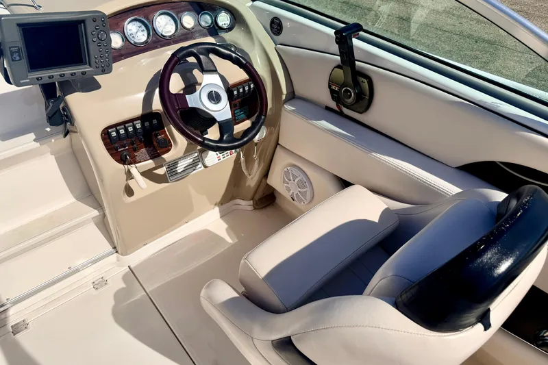 Slide: The Image of 2000 Chaparral 235 SSi boat cockpit with steering wheel, gauges, and navigation system. - 32