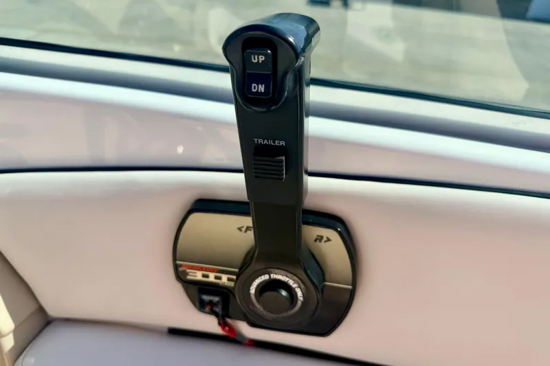 Slide: The Image of Throttle control lever on a 2000 Chaparral 235 SSi boat dashboard. - 36