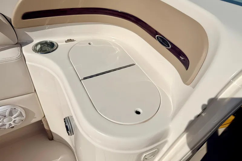 Slide: The Image of Interior detail of a 2000 Chaparral 235 SSi boat, featuring a storage compartment and cup holder. - 43