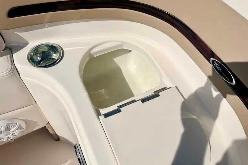 Slide: The Image of Chaparral 235 SSi 2000 boat interior with cup holder and storage compartment. - 45