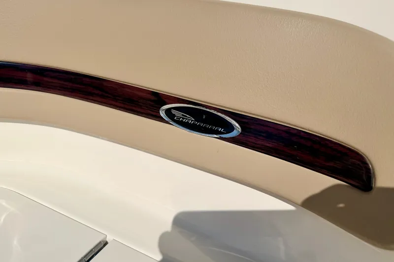Slide: The Image of Chaparral 235 SSi 2000 boat interior detail with logo and wood trim. - 46