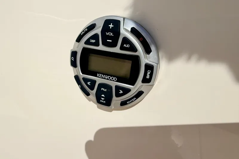 Slide: The Image of Kenwood audio control panel on 2000 Chaparral 235 SSi boat dashboard. - 48
