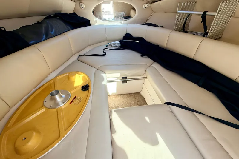 Slide: The Image of Interior of 2000 Chaparral 235 SSi boat with beige seating and storage compartments. - 51