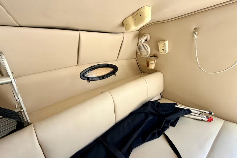 Slide: The Image of Interior of a 2000 Chaparral 235 SSi boat cabin with beige upholstery and accessories. - 52