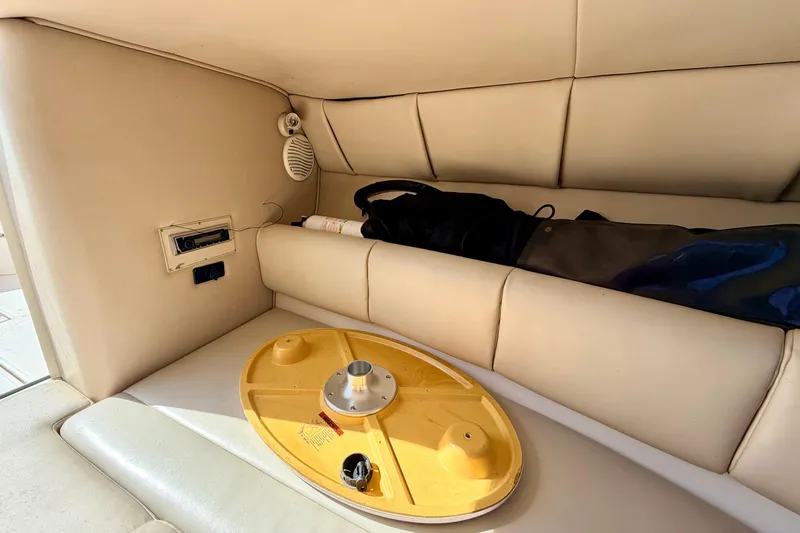 Slide: The Image of Interior of 2000 Chaparral 235 SSi boat with beige seating and storage area. - 53