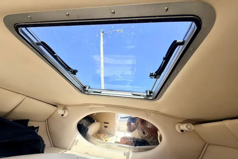Slide: The Image of Interior view of a 2000 Chaparral 235 SSi boat cabin with a skylight. - 56