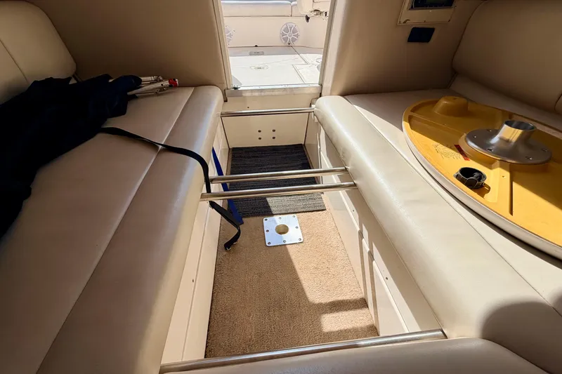 Slide: The Image of Interior of 2000 Chaparral 235 SSi boat with beige seating and storage compartments. - 58
