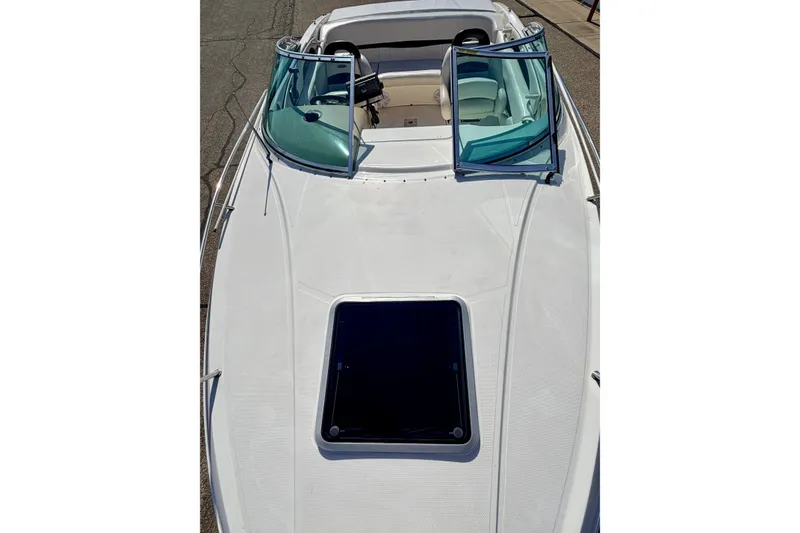 Slide: The Image of 2000 Chaparral 235 SSi boat with open windshield and sunroof on deck. - 60