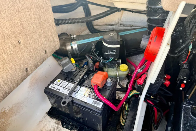 Slide: The Image of Battery compartment of a 2000 Chaparral 235 SSi boat, showing wiring and components. - 63