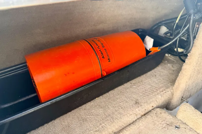 Slide: The Image of Orange marine signal device inside 2000 Chaparral 235 SSi boat compartment. - 64