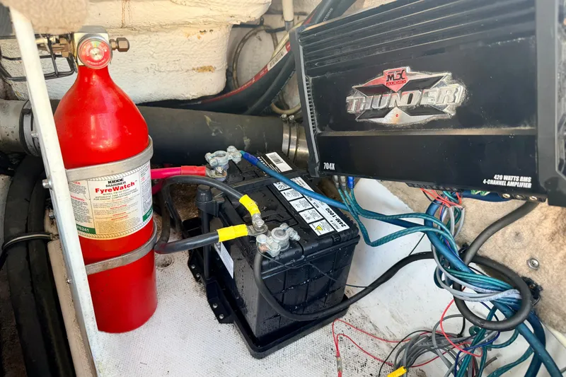 Slide: The Image of Engine compartment of 2000 Chaparral 235 SSi with fire extinguisher, battery, and amplifier. - 65
