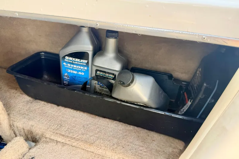 Slide: The Image of Boat storage compartment with Quicksilver marine oil bottles, Chaparral 235 SSi, 2000 model. - 66