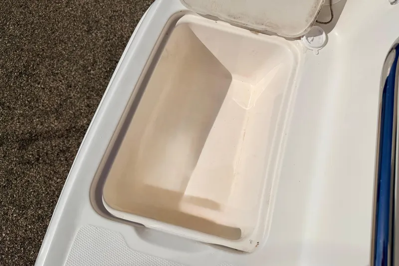Slide: The Image of Open storage compartment on a 2000 Chaparral 235 SSi boat, showing interior space. - 68
