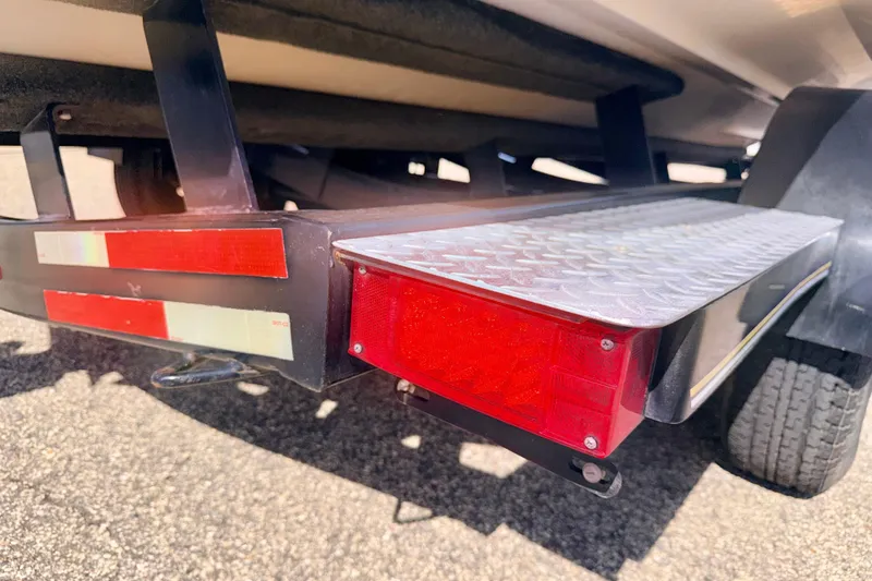 Slide: The Image of Trailer of a 2000 Chaparral 235 SSi boat with red reflectors and metal step. - 69