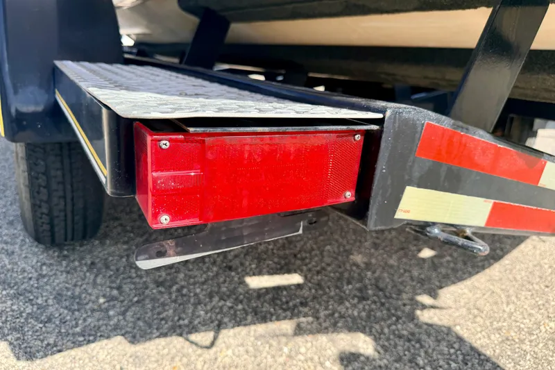 Slide: The Image of Trailer light and bumper of a 2000 Chaparral 235 SSi boat on asphalt. - 70