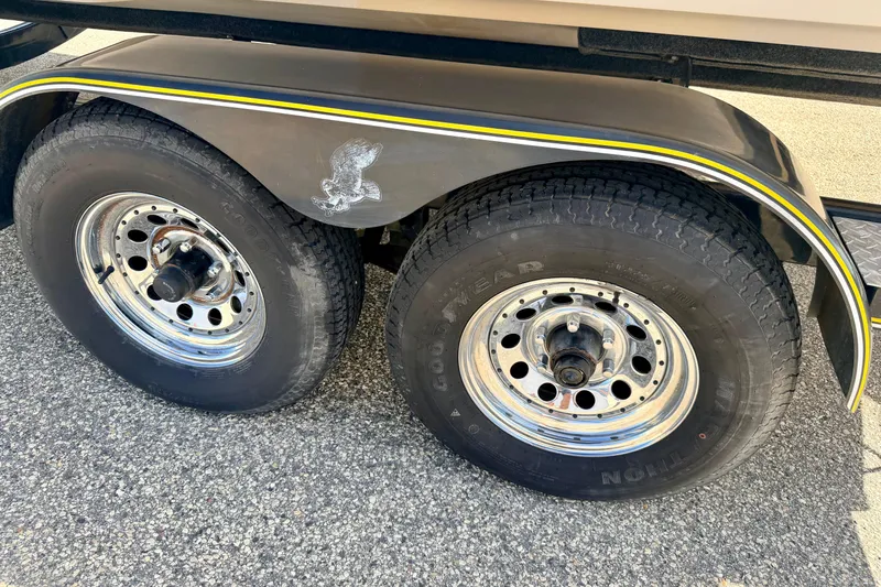 Slide: The Image of Trailer wheels of a 2000 Chaparral 235 SSi boat, featuring chrome rims and Goodyear tires. - 73