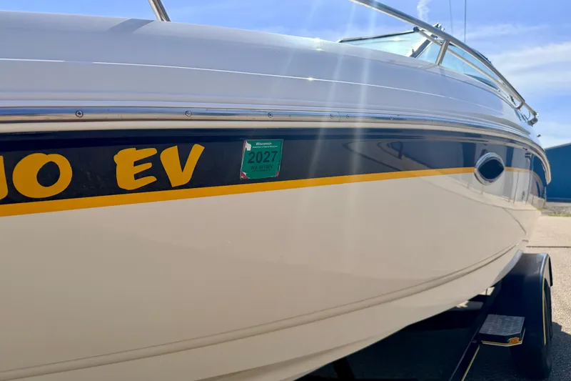 Slide: The Image of 2000 Chaparral 235 SSi boat with Wisconsin registration sticker, parked on a trailer. - 75