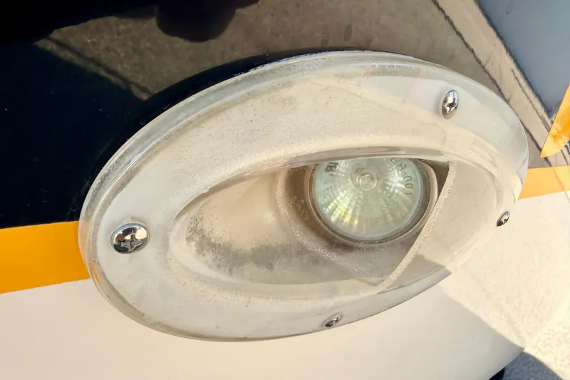 Slide: The Image of Close-up of a 2000 Chaparral 235 SSi boat light fixture with screws. - 77