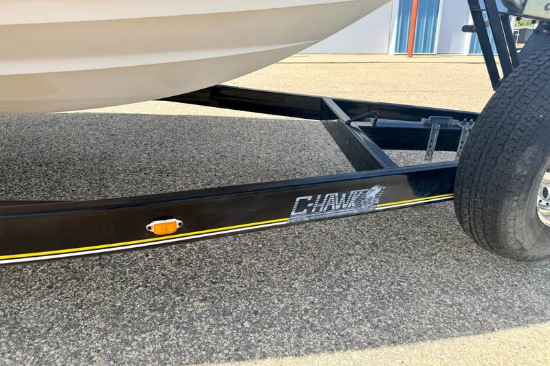 Slide: The Image of Trailer for 2000 Chaparral 235 SSi boat on asphalt surface. - 8