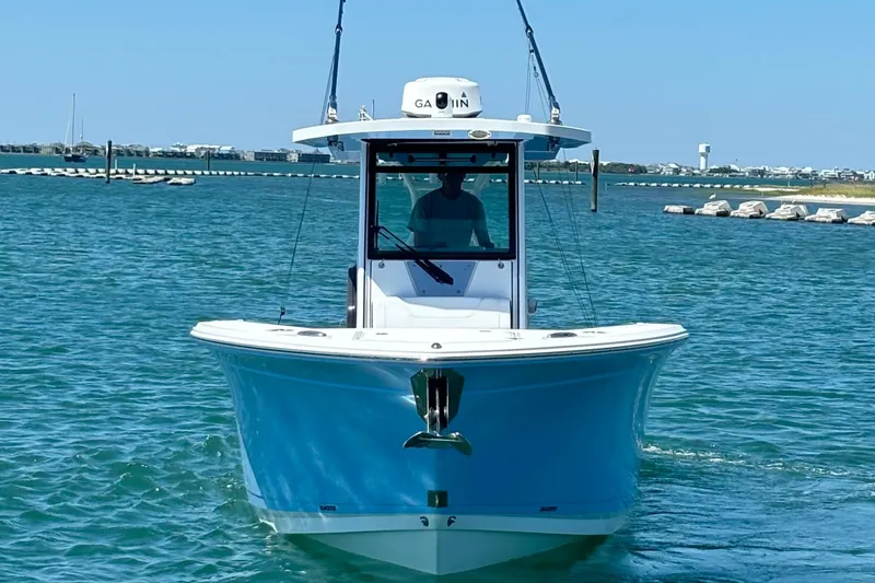 Slide: The Image of 2024 Blackfin 272 CC boat cruising on clear blue water. - 10