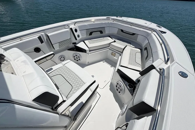 Slide: The Image of 2024 Blackfin 272 CC boat interior with luxurious seating and modern design on the water. - 11