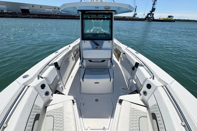 Slide: The Image of 2024 Blackfin 272 CC boat interior with spacious seating and modern design on the water. - 13