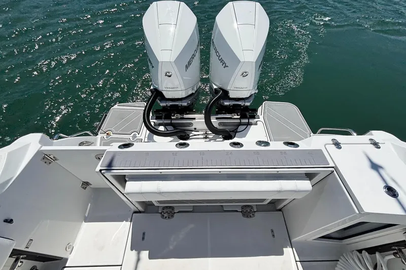 Slide: The Image of 2024 Blackfin 272 CC boat with dual Mercury engines on open water. - 14