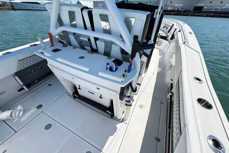 Slide: The Image of 2024 Blackfin 272 CC boat interior with seating and fishing equipment on deck. - 17