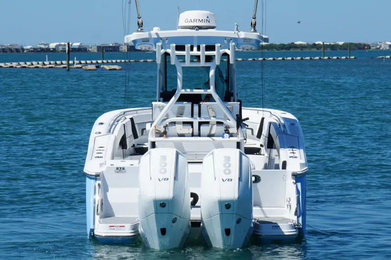 Slide: The Image of 2024 Blackfin 272 CC boat with twin V8 engines on open water. - 3