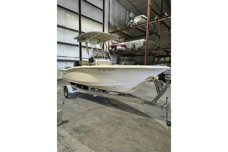 The Image of 2020 Scout 195 Sportfish boat on trailer in storage facility. - 1