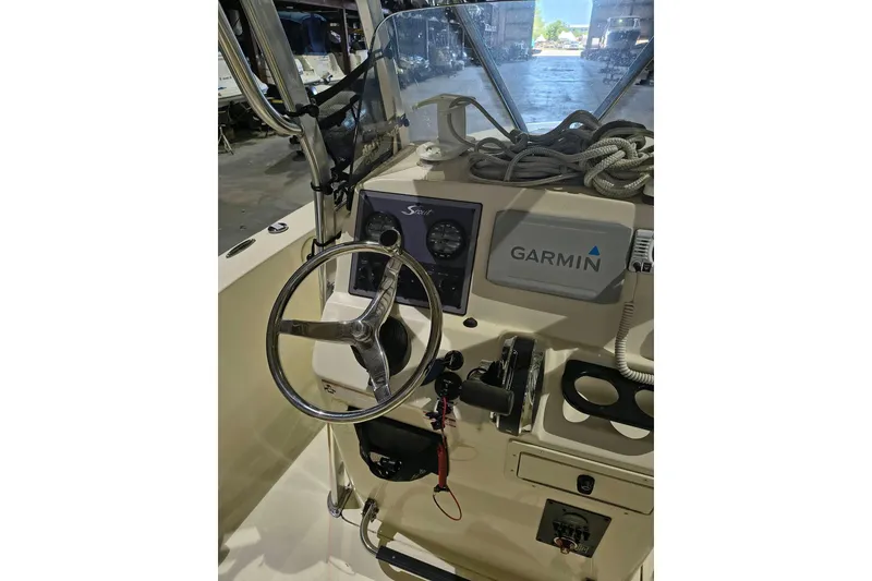 Slide: The Image of 2020 Scout 195 Sportfish boat dashboard with Garmin navigation system and steering wheel. - 11