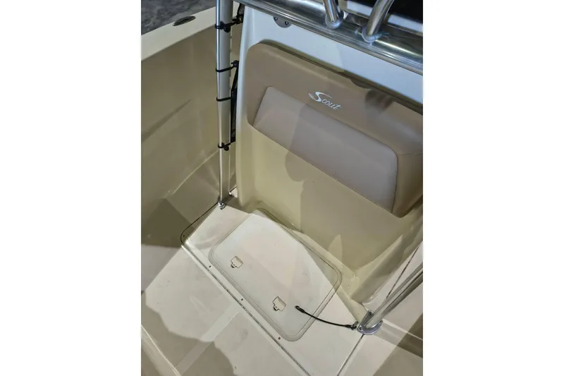 Slide: The Image of 2020 Scout 195 Sportfish boat interior with tan seating and storage compartment. - 14