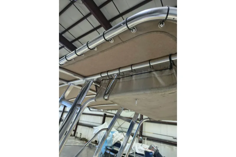 Slide: The Image of 2020 Scout 195 Sportfish boat canopy and frame detail in a storage facility. - 15