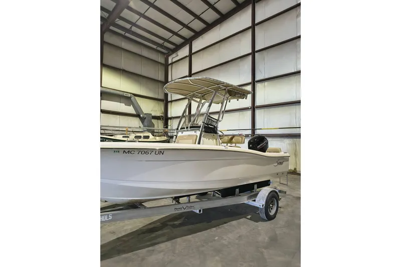 Slide: The Image of 2020 Scout 195 Sportfish boat on trailer in indoor storage facility. - 2