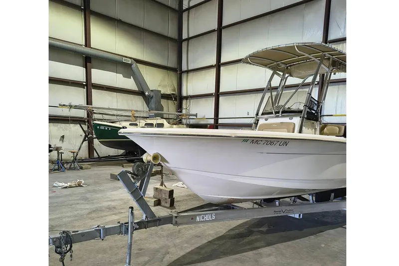 Slide: The Image of 2020 Scout 195 Sportfish boat in a warehouse on a trailer. - 3