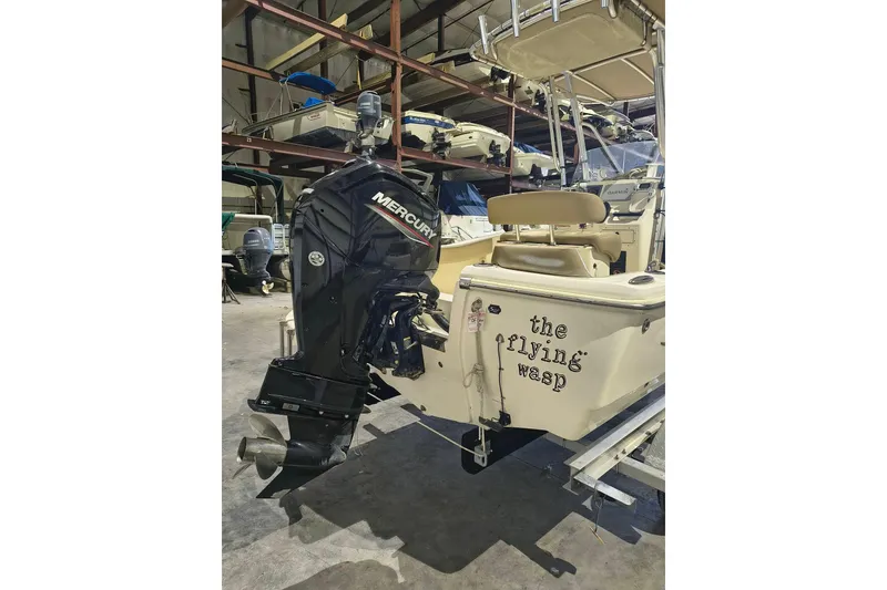 Slide: The Image of 2020 Scout 195 Sportfish boat with Mercury engine, named "The Flying Wasp," in storage. - 5